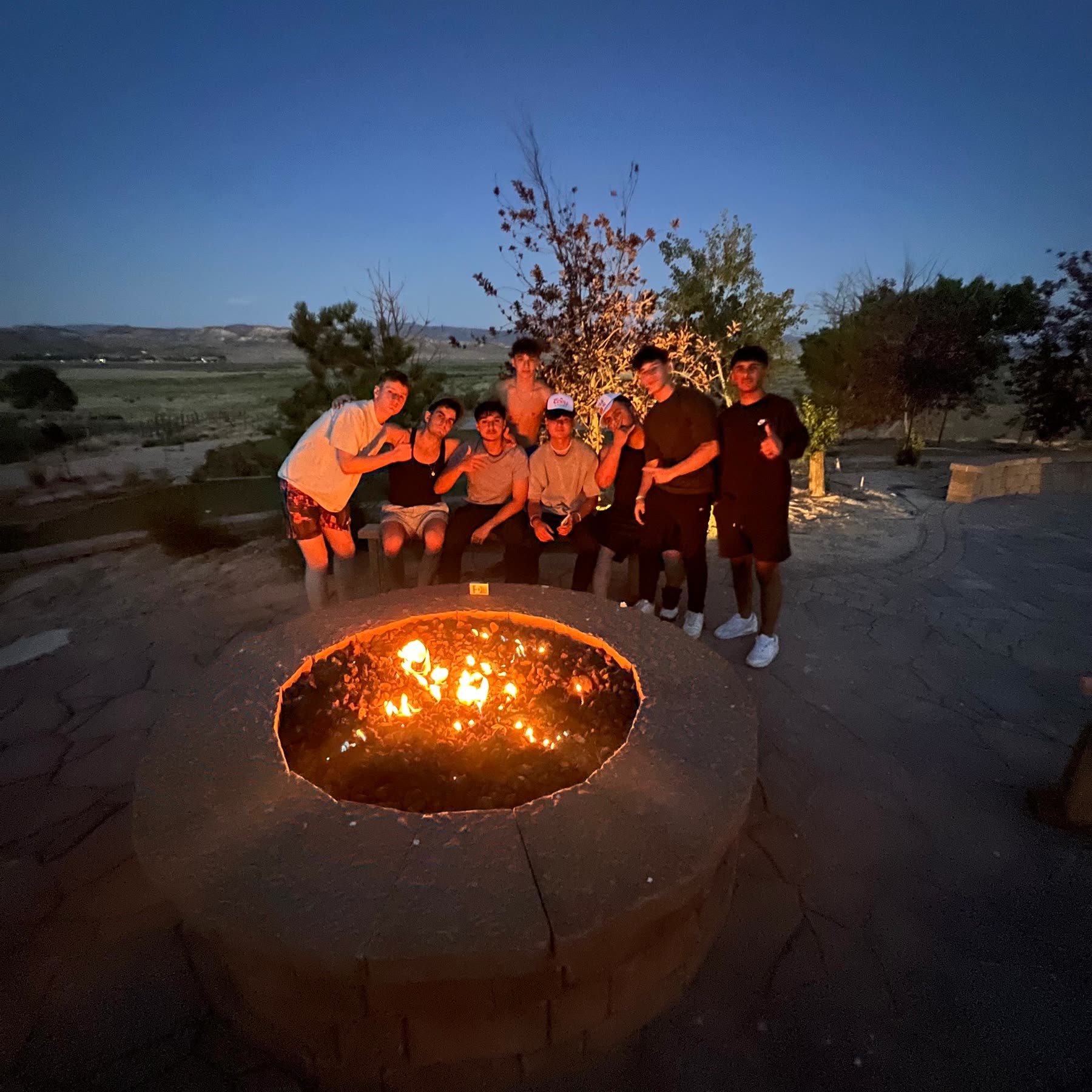 Group around a campfire at dusk