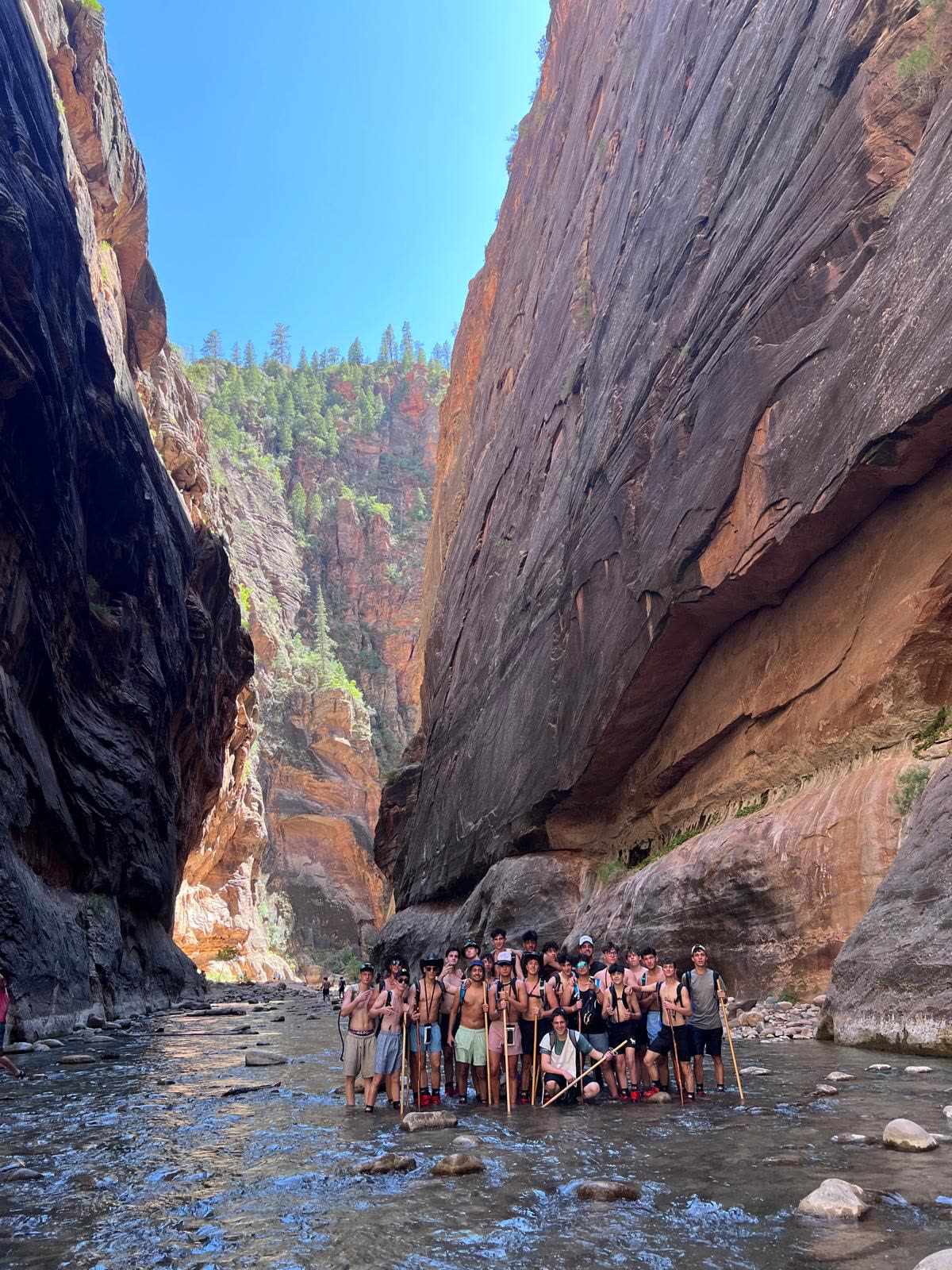 Group hiking through a river canyon