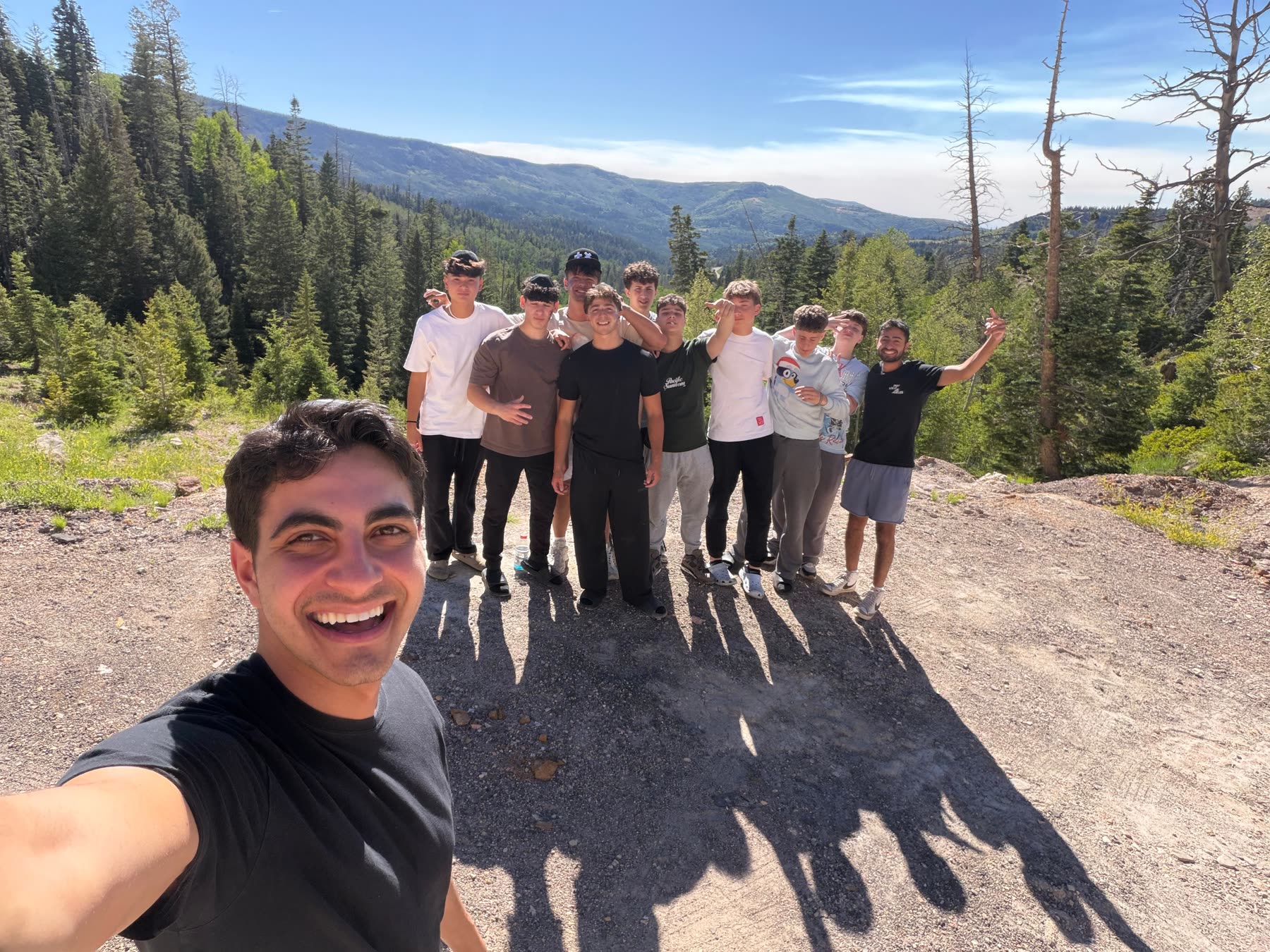 Campers taking a selfie together in the forest