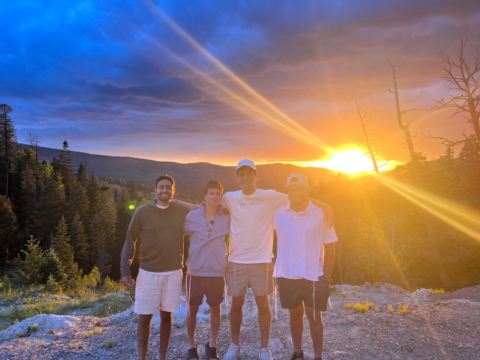 Staff and campers watching the sunset over the mountains