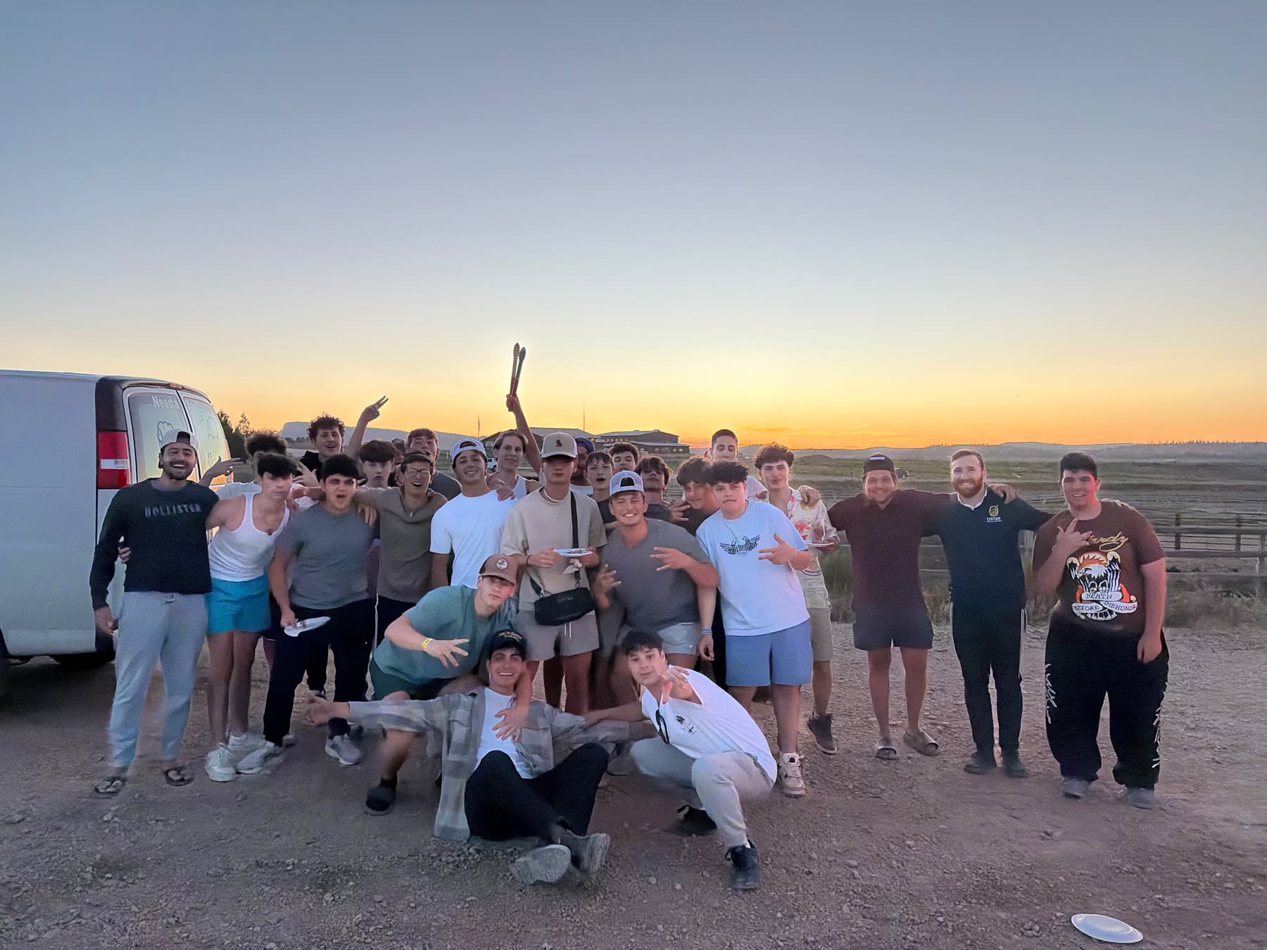 Group photo at sunset next to the van