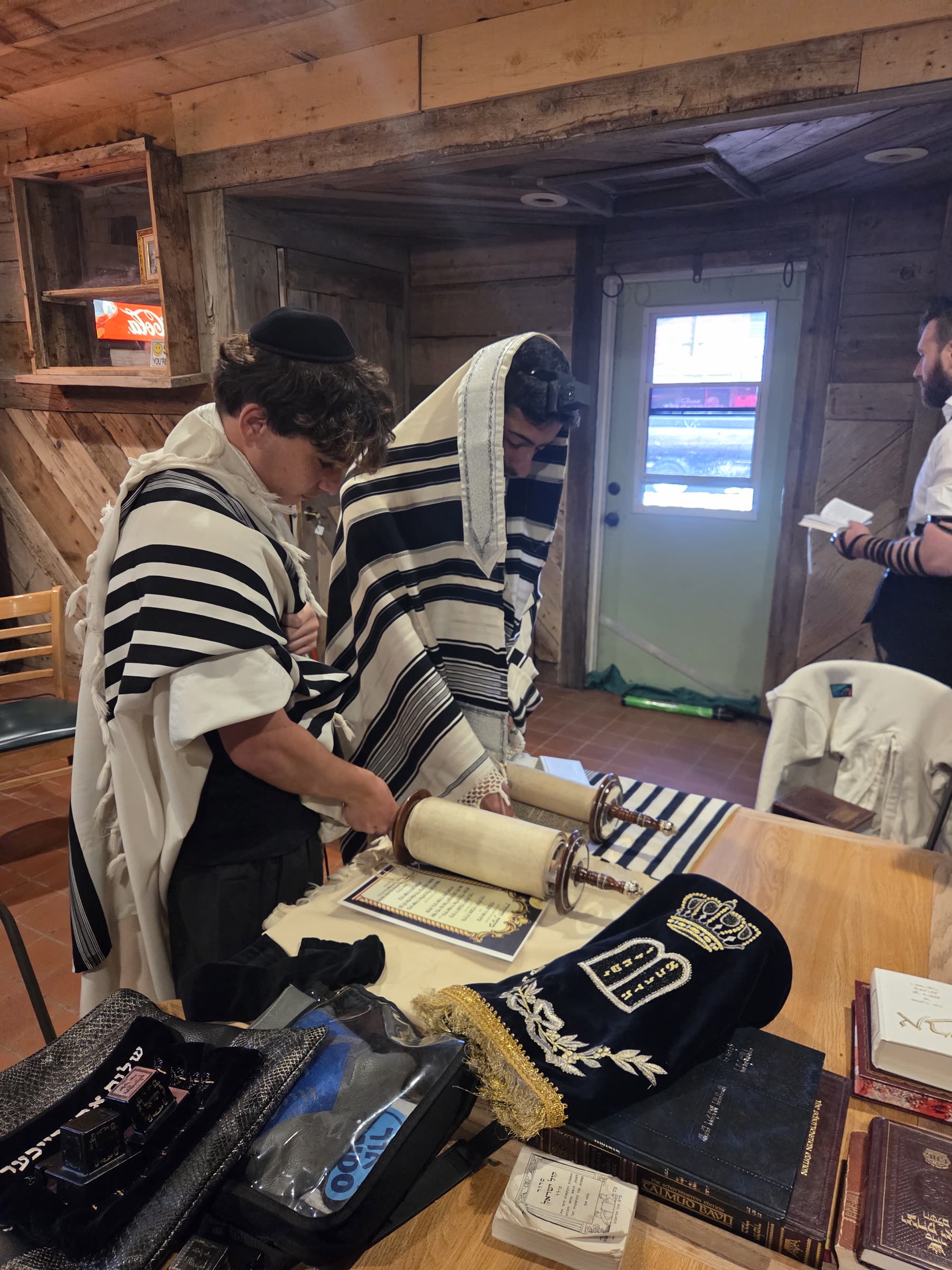Campers wearing tallit reading from the Torah