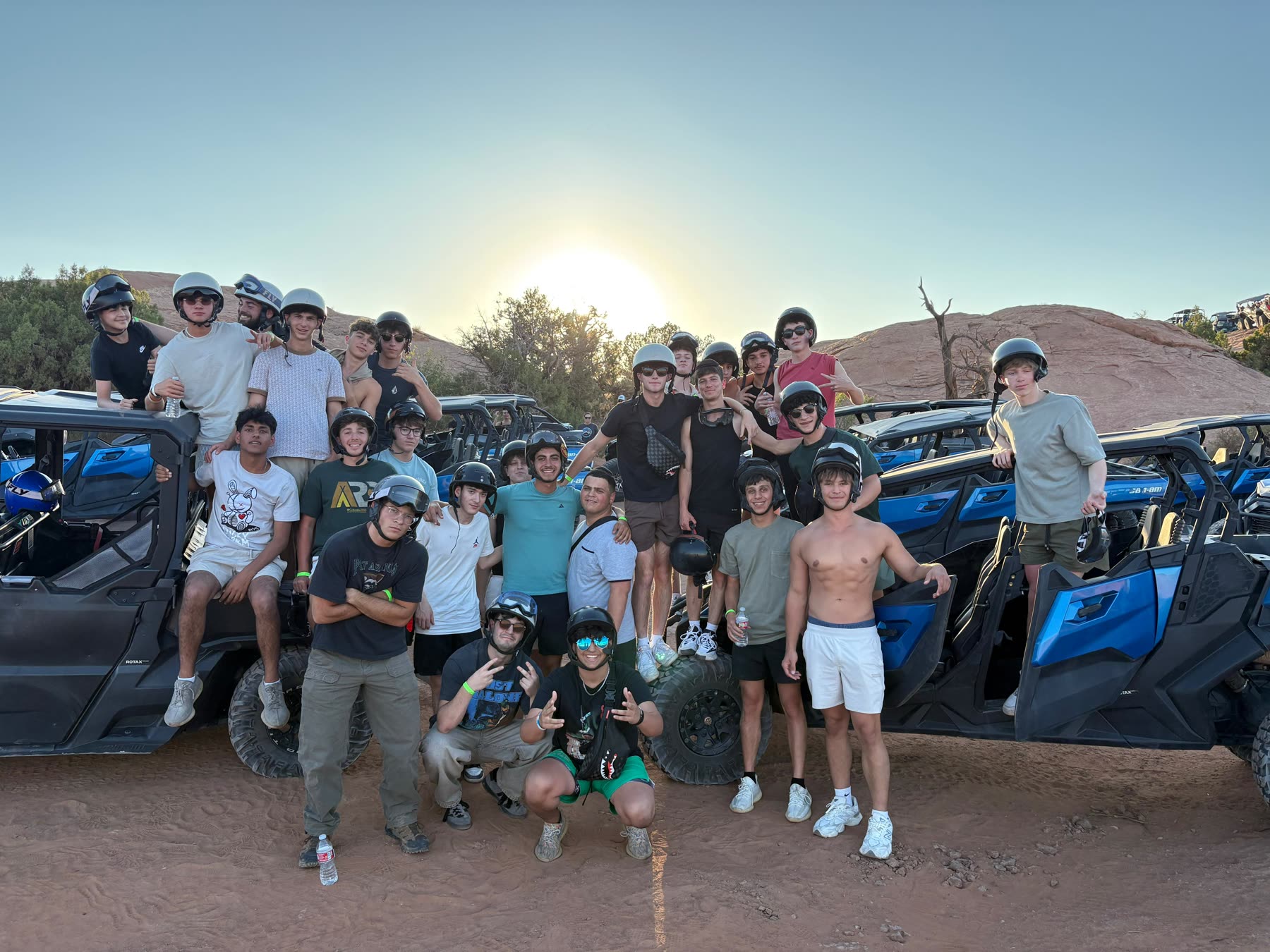 Group with off-road vehicles at sunset