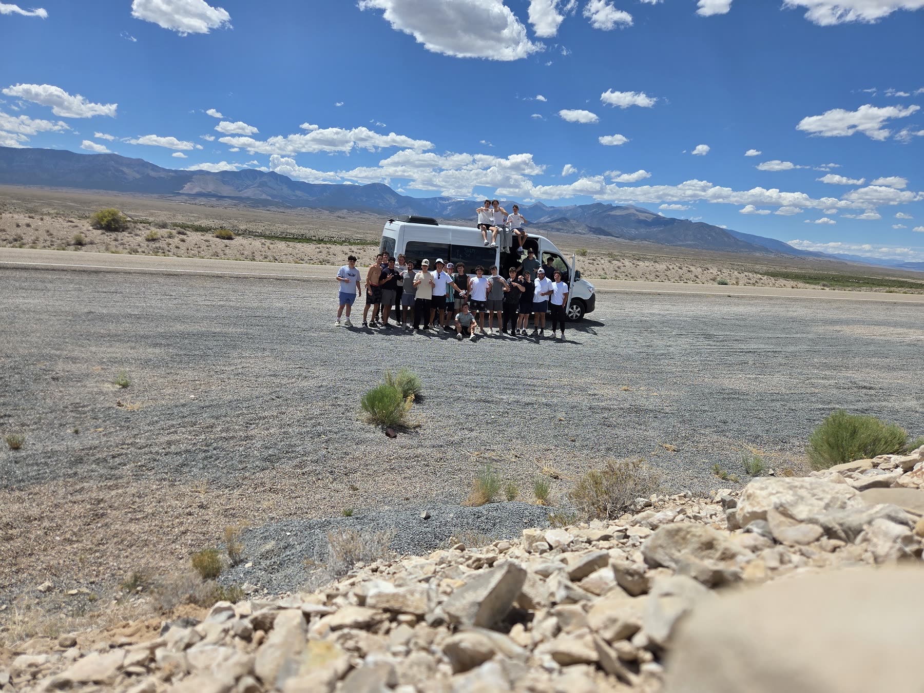 Van and group in the desert during a road trip