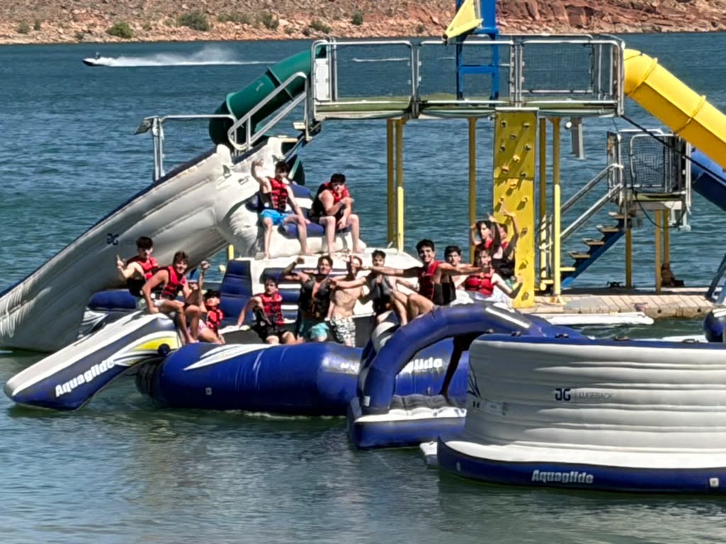 Group on an inflatable water park on the lake