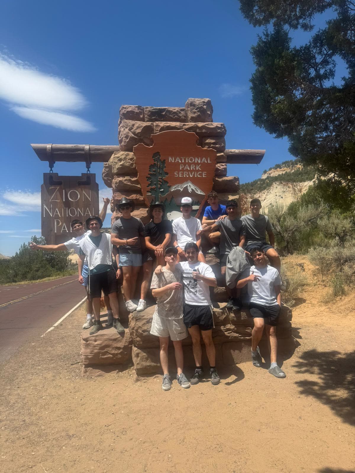 Group at the Zion National Park entrance sign
